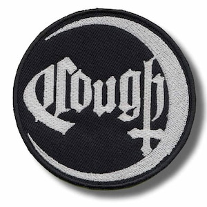 May include: A round, black patch with white embroidered text and a crescent moon design. The word "Cough" is written in a gothic font, with a cross symbol below. The patch has a white border.