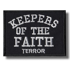 May include: Black rectangular patch with white embroidered text. The text reads "KEEPERS OF THE FAITH" arched at the top, with "TERROR" at the bottom. The patch has a black border and a shadow.