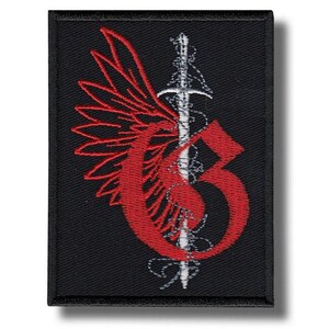 May include: Black embroidered patch featuring a red winged design with a sword and the letter "G". The patch has a rectangular shape and is likely designed to be sewn or ironed onto clothing or accessories.