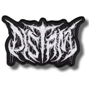May include: A black and white embroidered patch with the word "DISTORT" in a gothic font. The patch has a black border and is designed to be sewn or ironed onto clothing or accessories.