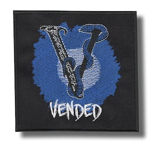 May include: Black square patch with a blue and white embroidered design. The design features a stylized letter "V" with a snake-like element, set against a blue circular background. The word "VENDED" is embroidered in white below the design.