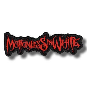 May include: A black embroidered patch featuring the words "Motionless In White" in red, gothic-style lettering. The patch has a black border and is designed to be sewn or ironed onto fabric items such as jackets or bags.