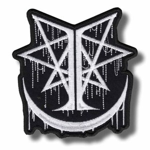 May include: Black and white embroidered patch with a distinctive design. The patch features a pentagram shape with a crescent moon at the base. White dripping lines and a central letter design are visible.