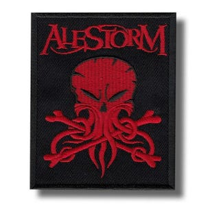 May include: Black embroidered patch featuring the word "ALESTORM" in red script above a red skull with tentacles and crossed bones. The patch is square and has a black border.