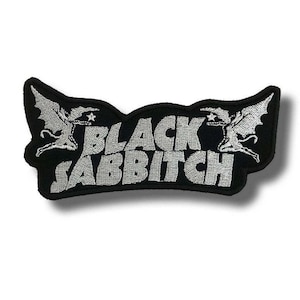 May include: Black embroidered patch with the text "BLACK SABBITCH" in silver, in a stylized font. The patch features two winged figures on either side of the text, set against a black background.