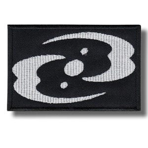 May include: Black rectangular patch with a white abstract design. The design features curved shapes and dots, creating a unique pattern. The patch is made of a woven material.