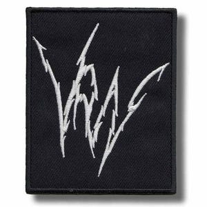 May include: Black rectangular patch with white embroidered text. The text appears to be a stylized logo or emblem with sharp, angular lines. The patch has a black border and is likely designed to be sewn or ironed onto fabric.