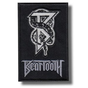 May include: Black rectangular patch with a white and grey embroidered design. The design features a stylized letter "T" and a figure, with the word "BEARTOOTH" embroidered below in grey. The patch is likely for clothing or accessories.