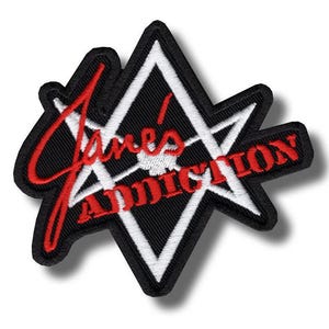 May include: Embroidered patch featuring the text "Jane's Addiction" in red script and block letters. The patch has a black background with a white geometric design and a black border. The patch is in the shape of a star.