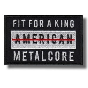以下が含まれることがあります： 「FIT FOR A KING」と「AMERICAN METALCORE」という白い文字が書かれた黒い長方形のパッチ。 「AMERICAN」という単語は、赤い線が入った白い長方形の中にあります。 パッチには黒い縁があります。