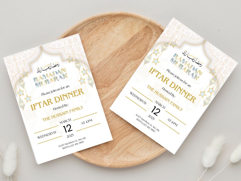 May include: Two white invitation cards with gold and blue accents. The cards announce an Iftar Dinner for Ramadan Mubarak, hosted by The Hussain Family on Wednesday, March 12th at 4 PM. The cards feature a decorative design with stars and an archway.