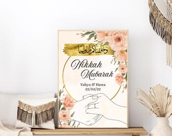 May include: A gold and white wedding sign with floral accents. The sign reads "Nikkah Mubarak" with the names "Yahya & Hawa" and the date "22/02/22".