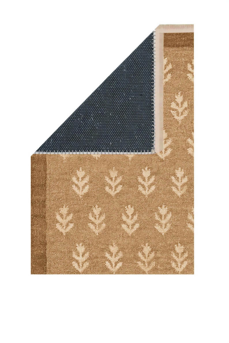 a rug with a floral pattern in shades of brown and black.