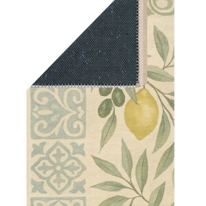 a decorative rug with a lemon and leaf pattern, and a dark blue geometric pattern on the left side.