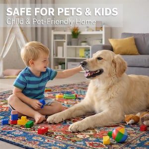 A young boy in a blue striped shirt is playing with a golden retriever dog on a colorful rug in a cozy living room.