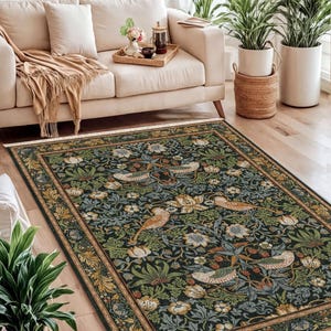 a cozy living room with a large, ornate rug featuring a floral design in shades of green and gold. The room is furnished with a white sofa, a wooden coffee table, and several potted plants. The arrangement of the furniture and the rug creates a harmonious and inviting atmosphere.