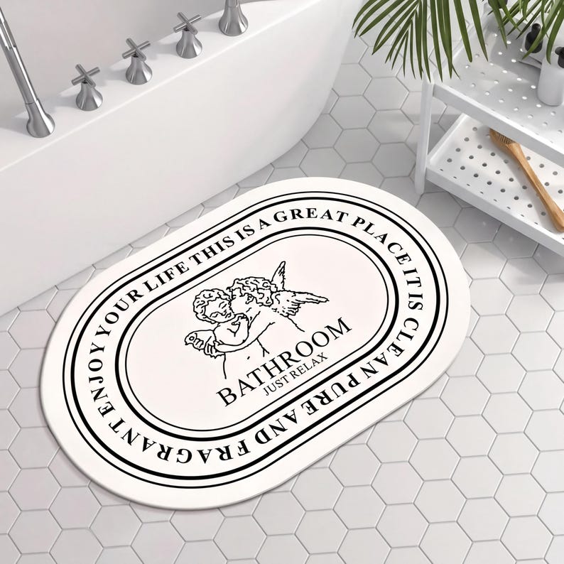 a bathroom with a white oval-shaped bath mat with a decorative design and text on it.