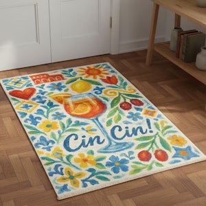 May include: Rectangular rug with a cocktail glass design. The rug features a vibrant illustration of a cocktail, surrounded by flowers, lemons, and cherries. The words "Cin Cin!" are written in blue. The rug is on a wooden floor.