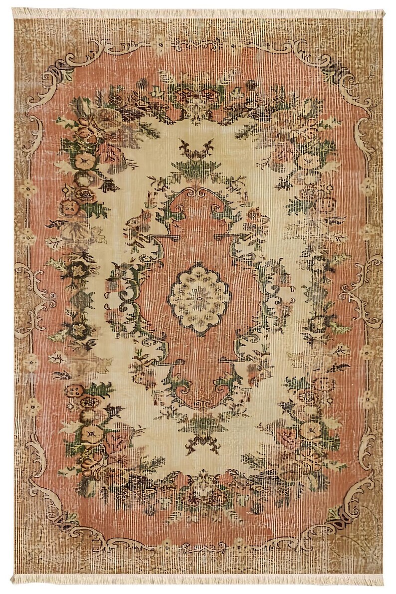 May include: A rectangular rug with a distressed, vintage look. The rug features a central cream-colored field with a floral pattern in shades of pink, green, and brown. The border is a darker brown with floral and scroll designs.