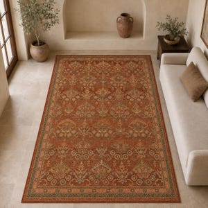 May include: A rectangular area rug featuring a deep rust-orange base color with an intricate, repeating floral and botanical pattern in muted shades of sage green, cream, and brown, finished with a decorative border along all four edges.