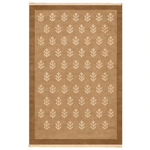 a rectangular rug with a repeating pattern of white leaf-like designs on a beige background.