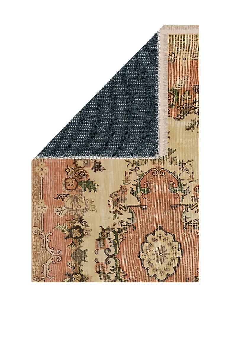 May include: A section of a vintage-style rug with a distressed floral pattern in shades of peach, cream, and olive green. The rug has a dark blue backing and a fringed edge. The design features ornate botanical motifs.