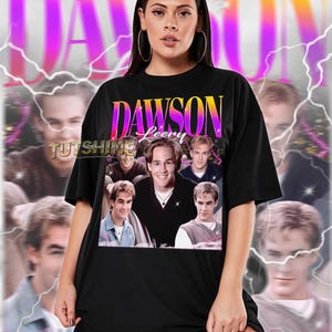 May include: Black unisex t-shirt featuring a graphic of the show "Dawson's Creek" with the text "DAWSON Leery". The shirt has a vintage design with a photo collage of the cast. The text "TUTSHINE" is also visible.