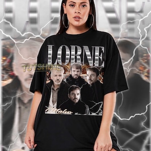 May include: Black t-shirt with the word "LORNE" in silver block letters and a graphic of four men. The word "Malvo" is printed below the graphic. The shirt is worn by a person.