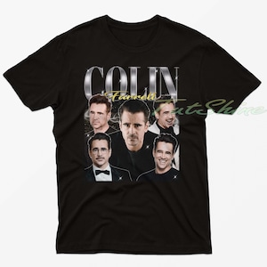 May include: Black t-shirt featuring a collage of Colin Farrell's images. The design includes the name "COLIN Farrell" in silver and gold lettering. The shirt showcases various portraits of the actor, creating a vintage-style aesthetic.