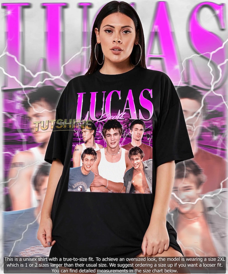 May include: Black unisex t-shirt with a pink and white "LUCAS Scott" design and a collage of images. The shirt has a crew neck and short sleeves. The text "TUTSHINE" is also visible. The shirt is worn by a person.