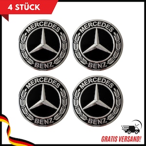 May include: Four Mercedes-Benz emblem badges. Each badge is circular with a black background and a silver Mercedes-Benz logo. The text "MERCEDES" and "BENZ" are in silver. The top left corner reads "4 STÜCK".