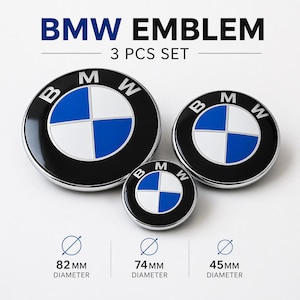 May include: Three BMW emblem set with black, white, and blue circular designs. The set includes emblems with diameters of 82mm, 74mm, and 45mm. The text "BMW EMBLEM" and "3 PCS SET" are displayed above the emblems.