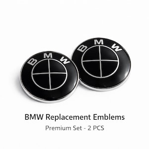 以下が含まれることがあります： シルバーの縁取りが付いた、黒いBMW交換用エンブレムが2つ。各エンブレムには、白い文字で「B」、「M」、「W」と書かれたBMWのロゴが表示されています。「BMW Replacement Emblems」と「Premium Set - 2 PCS」の文字が下にあります。