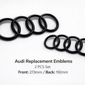 May include: Two sets of black Audi replacement emblems. The front emblem measures 27.3cm, and the back emblem is 19.2cm. The emblems are glossy and feature the iconic four-ring design, set against a white background.