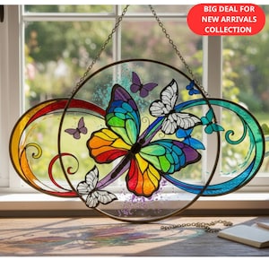 May include: A stained glass butterfly window hanging with a rainbow-colored butterfly at the center. The window art features a circular design with additional butterflies in shades of purple, blue, and white. The text "BIG DEAL FOR NEW ARRIVALS COLLECTION" is in the upper right corner.