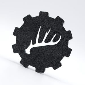 May include: Black gear-shaped sticker with a white silhouette of an elk antler.