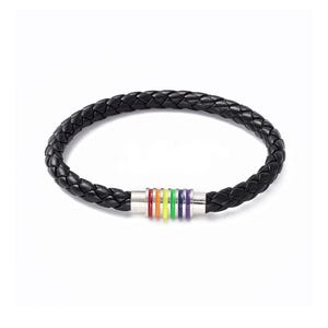 May include: A black braided leather bracelet featuring a cylindrical silver-tone metal clasp. The clasp is decorated with a series of thin, vertical enamel rings in a rainbow sequence of red, orange, yellow, green, blue, and purple colors.