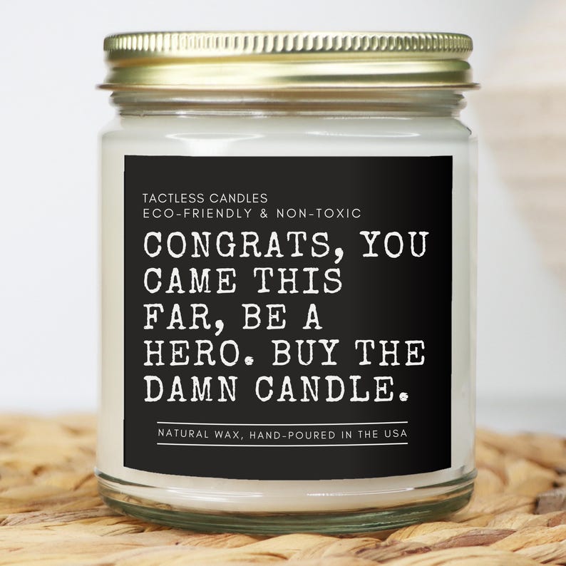 a candle with a quote on it sitting on a table
