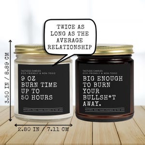 a couple of jars of candles sitting on top of a wooden table