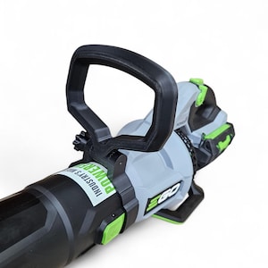 May include: A black and gray cordless leaf blower with a black handle and green accents. The blower has the text "EGO" and "INDUSTRY'S MOST POWERFUL" printed on it.