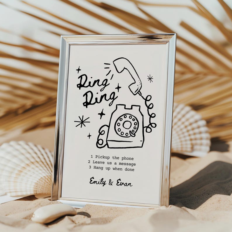 May include: A silver frame with a white background and a black and white illustration of a rotary phone with the text "Ring Ring" and instructions to "Pickup the phone, Leave us a message, Hang up when done". The names "Emily & Evan" are printed at the bottom of the frame.