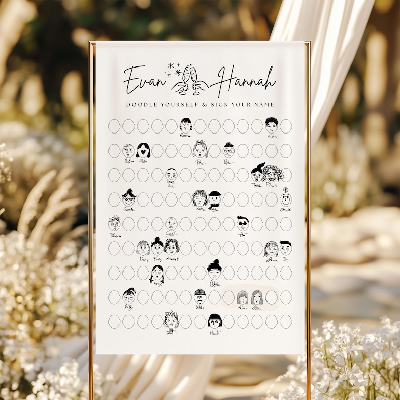 May include: A white wedding sign with gold trim, featuring the names "Evan & Hannah" and the prompt "Doodle Yourself & Sign Your Name." The sign has a series of blank spaces for guests to draw and sign their names, with whimsical doodle illustrations.