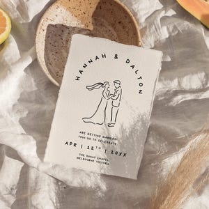 May include: A wedding invitation with the names "Hannah & Dalton" in a circular design. The invitation features a line drawing of a couple and the text "Are getting married! Join us to celebrate" and the date.