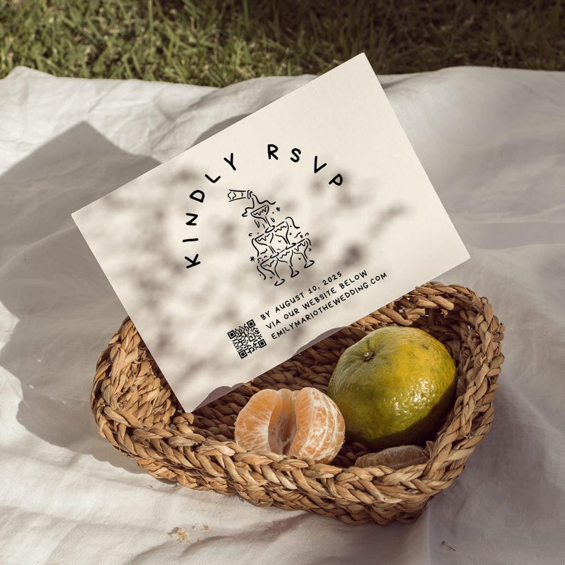 May include: A wedding RSVP card with the text "KINDLY RSVP" and a graphic of stacked champagne glasses. The card is in a woven basket with a tangerine and a whole orange. The card includes the date August 10, 2025 and a website address.