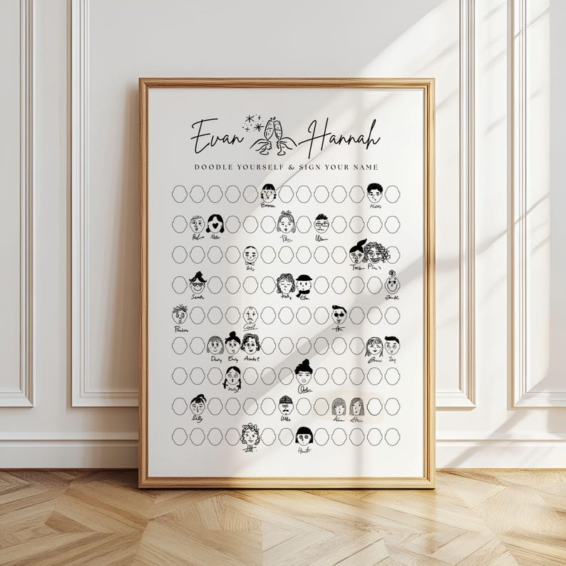 May include: A framed print with the names "Evan & Hannah" and the text "Doodle Yourself & Sign Your Name." The print features a grid of blank circles with doodle faces, ready for personalization. The frame is a warm gold color.