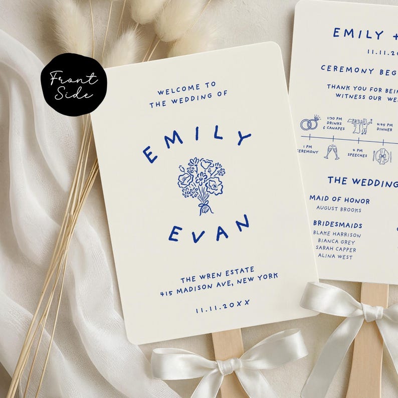 May include: Cream-colored wedding fan with navy blue text. The fan reads "Welcome to the Wedding of Emily & Evan" with the date and venue. A floral illustration is centered between the names. The fan is attached to a wooden stick with a white ribbon.