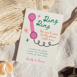 May include: A pink and green illustrated phone with the text "Ring Ring" and "We can't come to the phone right now". Below the phone is a list of instructions: "1. Pickup the phone, 2. Leave us a message, 3. Hang up when done". The text at the bottom of the card reads "Emily & Evan".