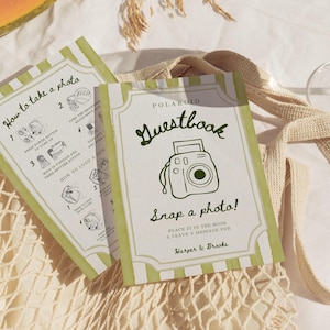 May include: Two rectangular guestbook instruction cards with light green and white vertical stripes. The front card features a dark green line drawing of a camera, the text "Polaroid Guestbook Snap a photo!", and "Harper & Brooks".