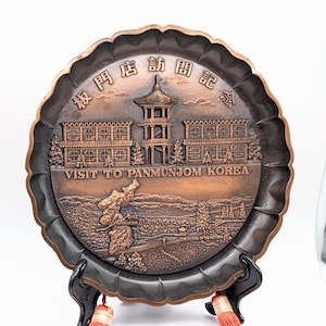 May include: A rustic wooden sign with the text "Welcome to our home" in white lettering. The sign has a distressed finish and a simple, inviting design, ideal for front door decor.