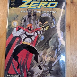 May include: A comic book titled "Doctor Zero 5" with a dynamic illustration. The cover features a costumed character with a red cape and a villainous figure. The comic is from December 1988, published by Epic Comics.
